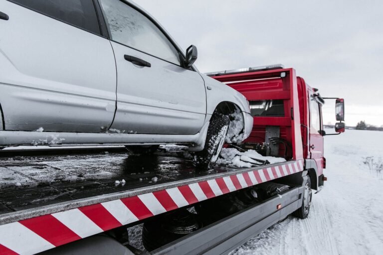 car-on-tow-truck-on-snow-road-NZ2KQJA